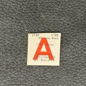 NOS Genuine Accutron by Bulova Part.  A 2180 186 .07 m/m black.  Fork Spacer.